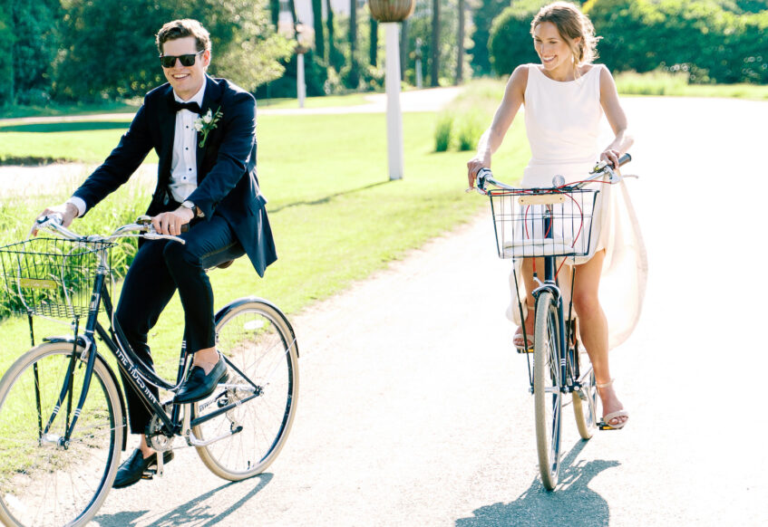 bride and groom riding bicycles